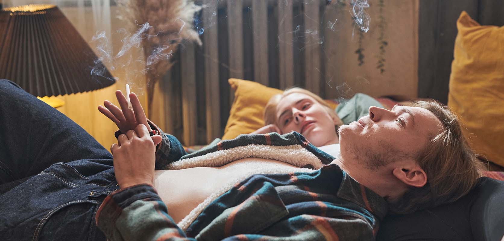 couple relaxing and smoking marijuana at home. order weed online. west coast cannabis online dispensary canada.