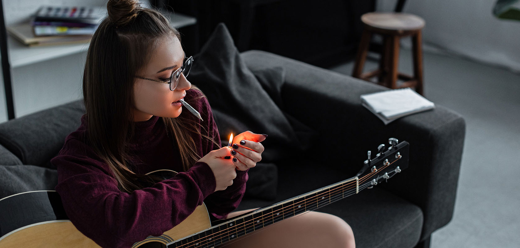 woman smoking weed and playing guitar. online mail order weed in canada
