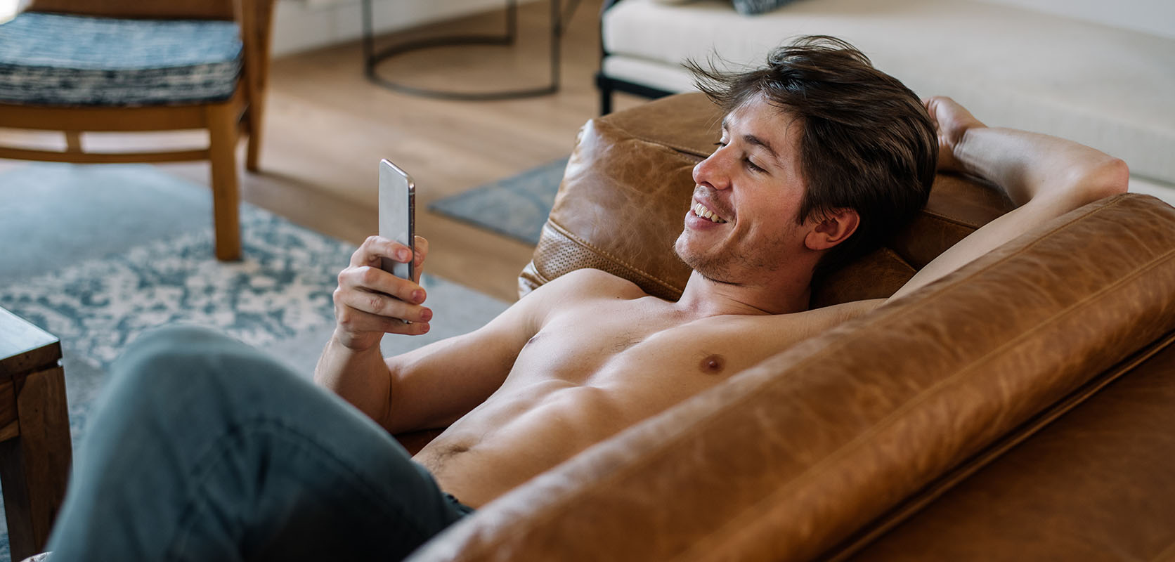 Man relaxing at home and on his phone buying weed online in canada