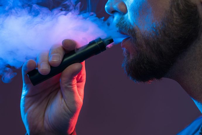 man vaping using a variety of dab pens for sale at west coast cannabis online dispensary.