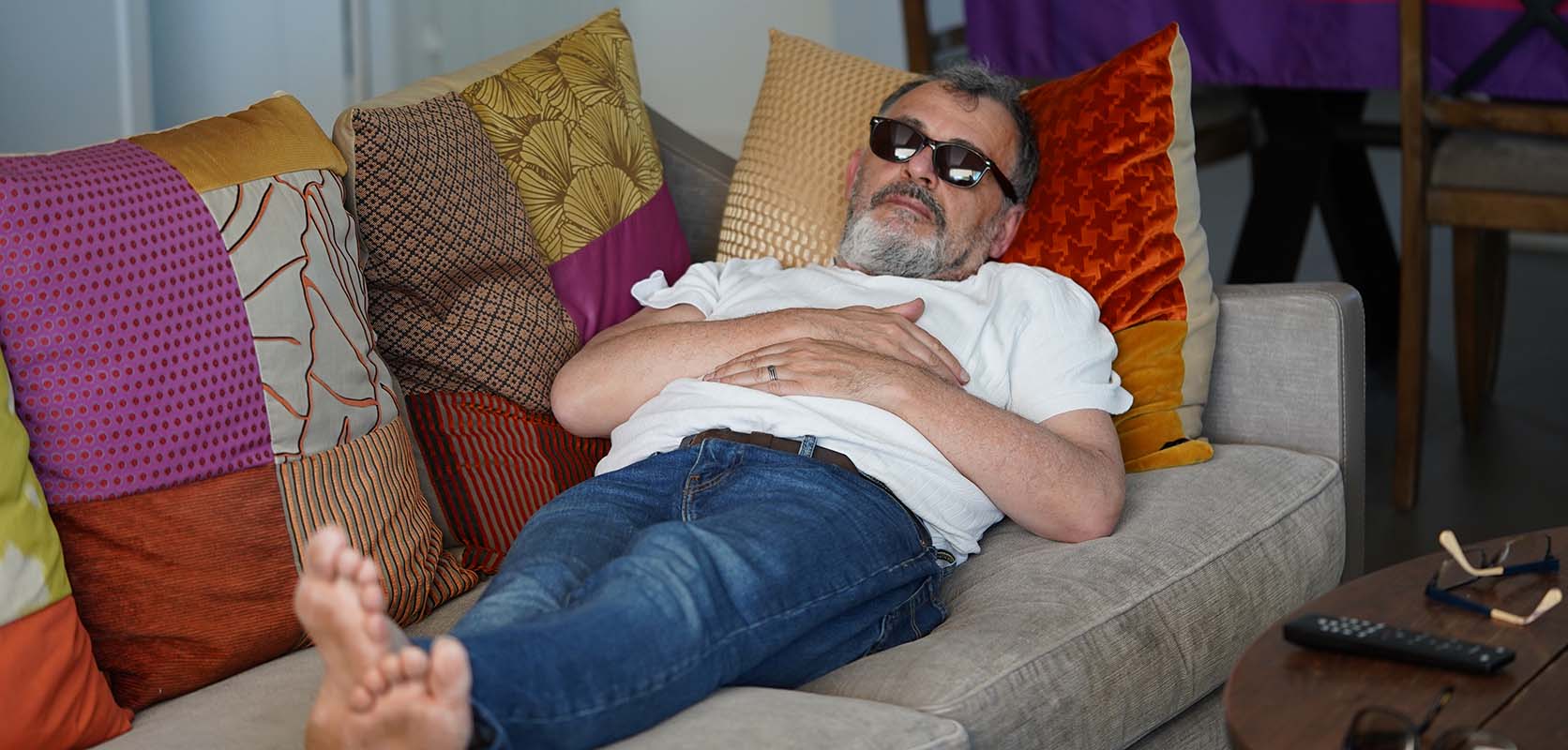 Adult man relaxing with couch lock after buying weed online