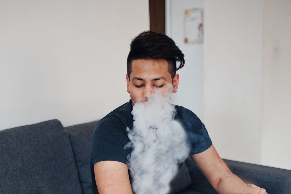 man blowing vape clouds after doing a dab for the first time. buy weed online in canada.