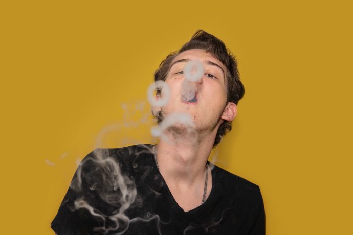 Man blowing smoke rings after learning how to dab. moon rock weed. pink kush strain, death bubba strain, zombie og strain, and strawberry shortcake strain weed online canada.