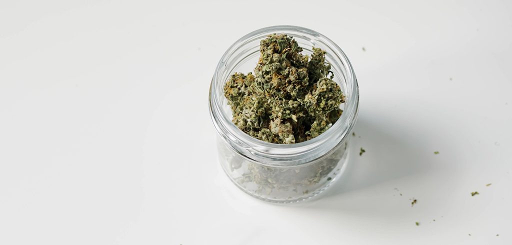 An ounce of weed in a glass jar. online dispensary canada to buy weeds online. cannabis canada. Dispencary.