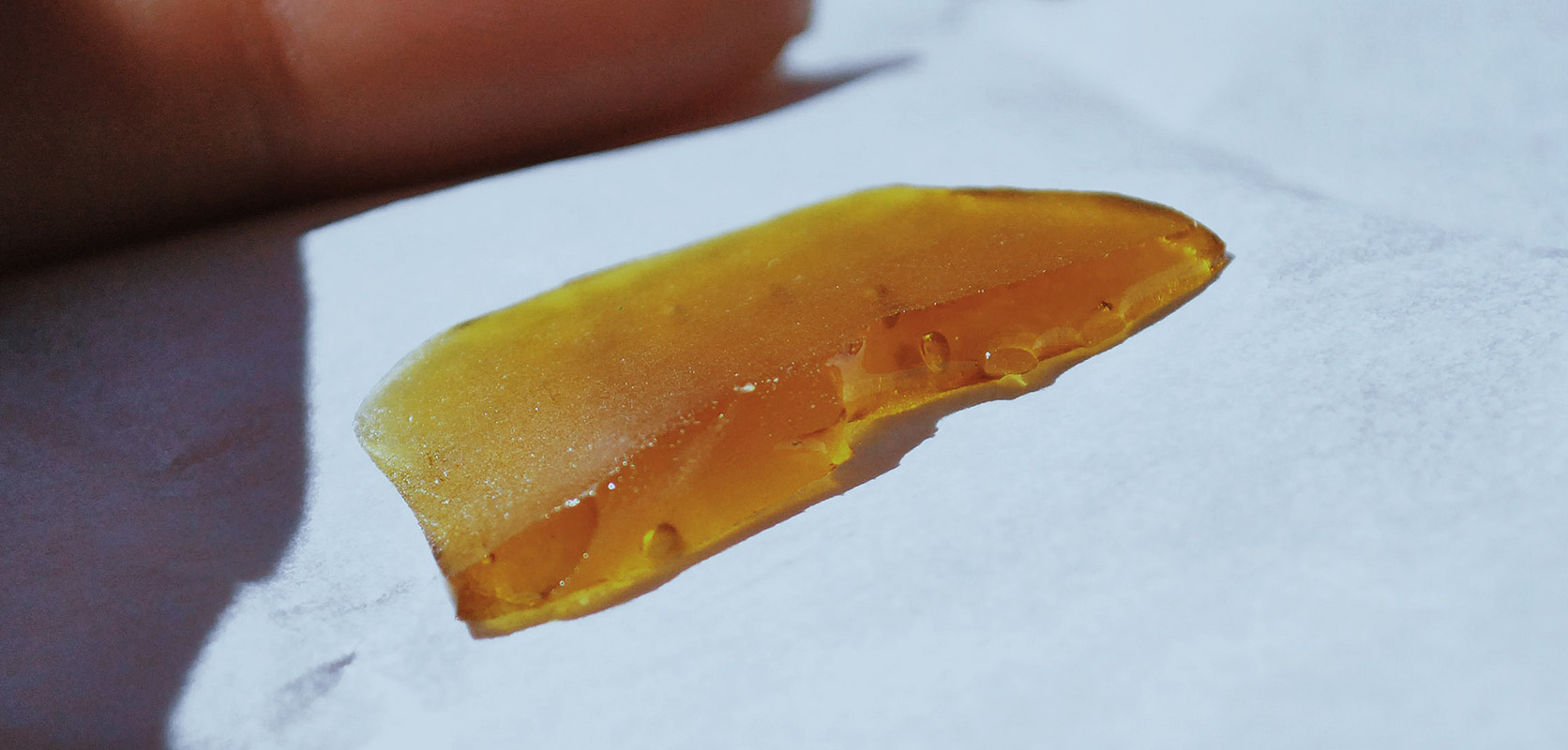 close up image of THC concentrate shatter wax. buy cannabis concentrates online. concentrates canada. dab drug. 