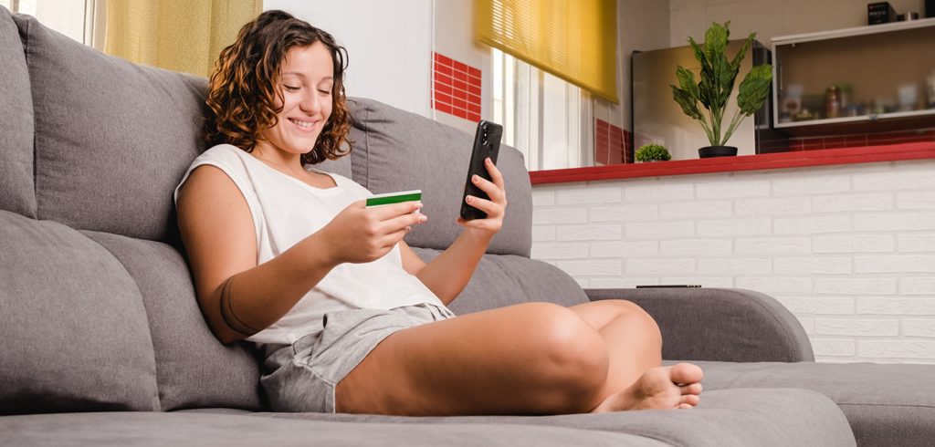 woman on the living room couch shopping online