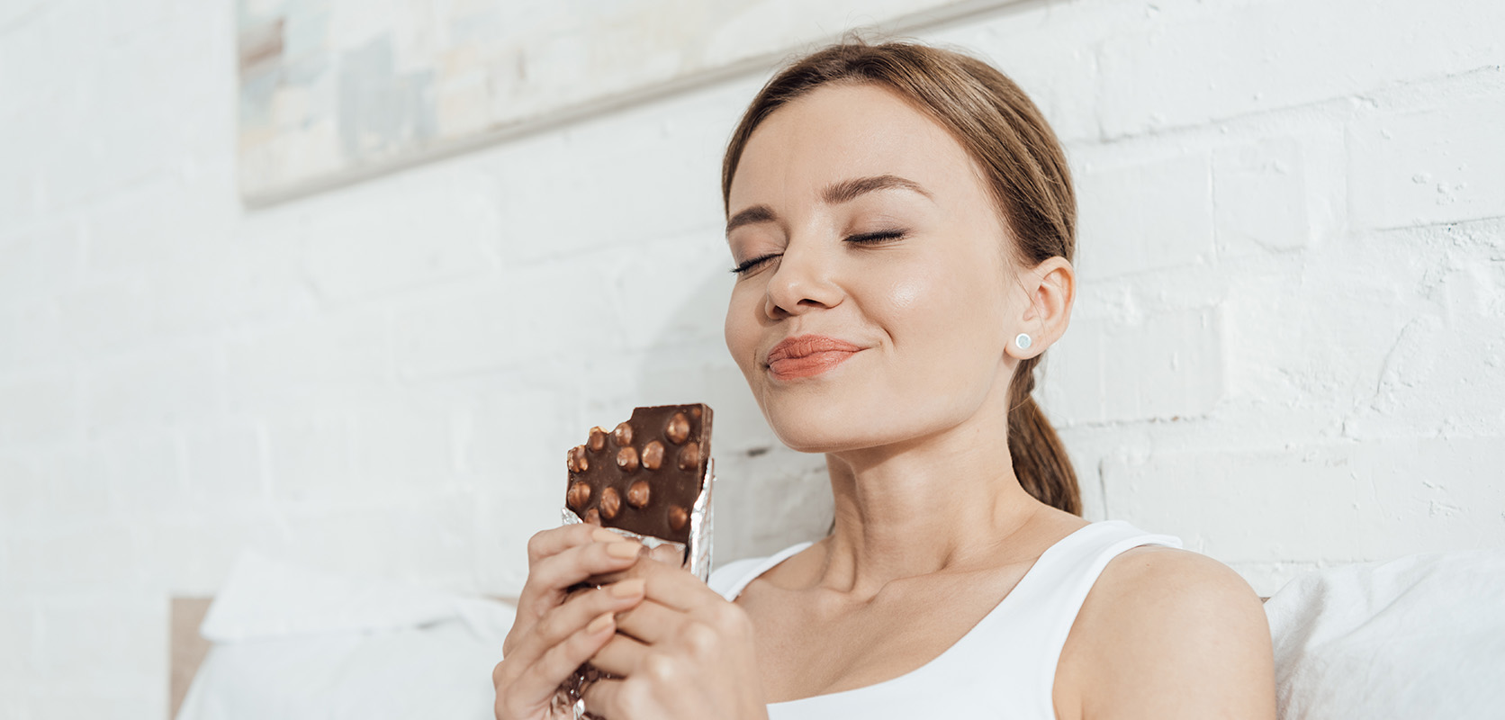 Woman enjoying weed chocolate candy bars and weed snacks from wccannabis dispensary for edibles online. buy weed online Canada.