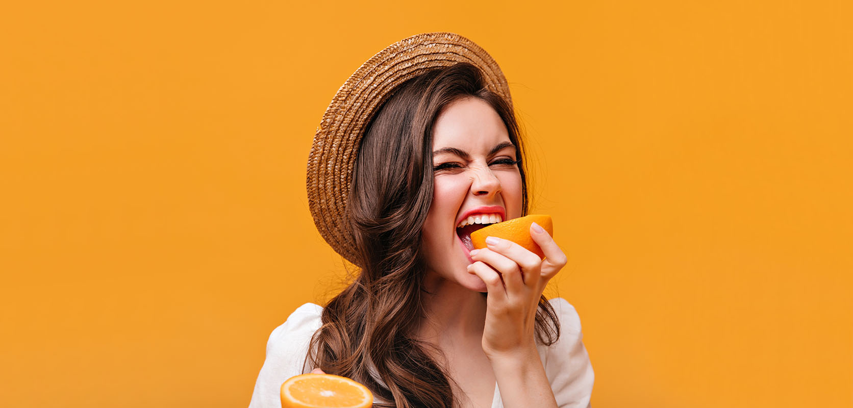 Woman eating an orange. Orange Crush Scout Strain review. buy weed online at west coast cannabis dispensary for value buds and cheapweed in canada. dispensary. 